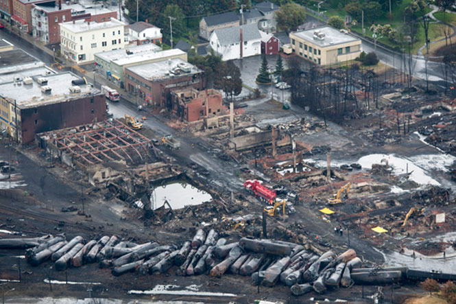 Workers comb through the debris after a train derailed causing explosions of railway cars carrying crude oil Tuesday, July 9, 2013 in Lac-Megantic, Que. (Photo: Paul Chiasson/CP)